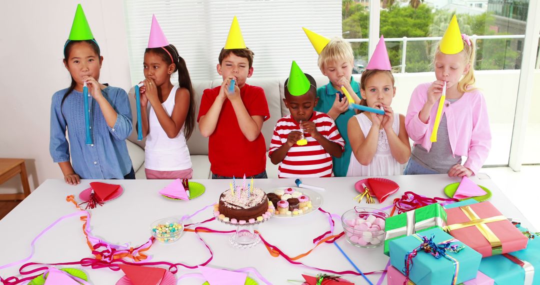 Diverse Children Joyfully Celebrating Birthday Party with Cake and Decorations - Free Images, Stock Photos and Pictures on Pikwizard.com