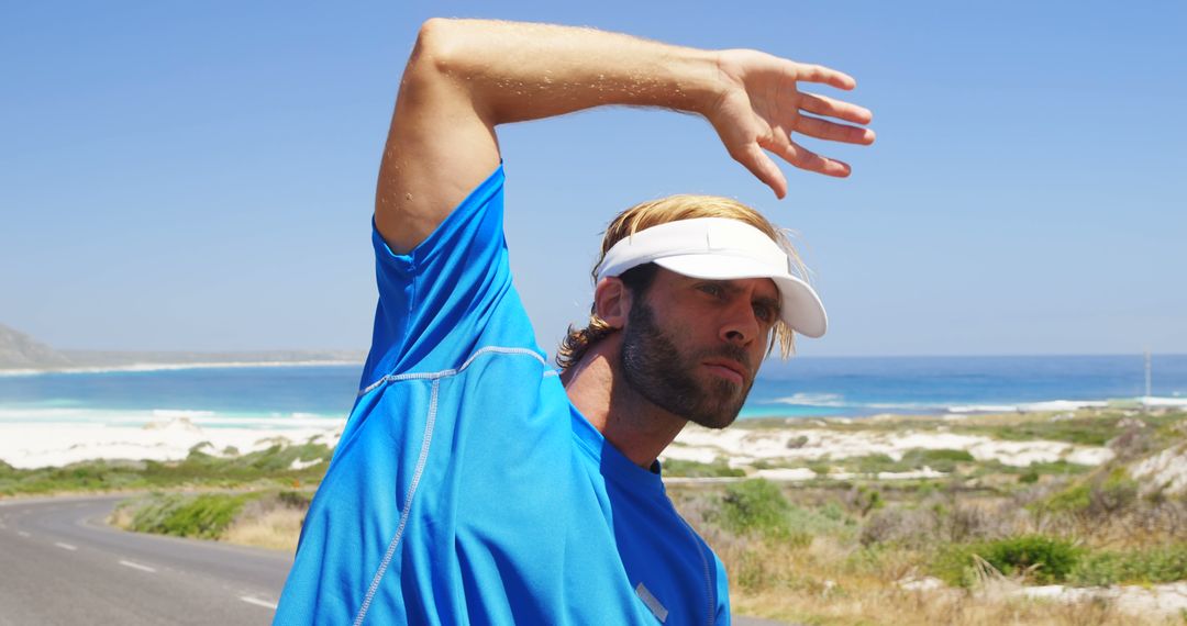 Male Athlete Stretching Outdoors Near Beach - Free Images, Stock Photos and Pictures on Pikwizard.com