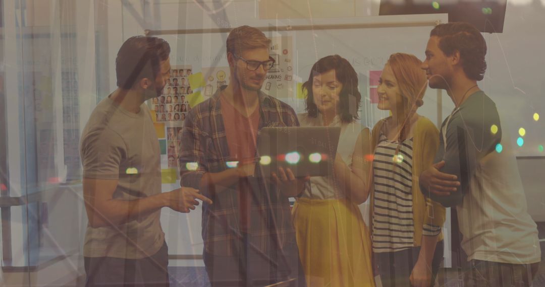 Office Team Collaborating with Stat Data Insights on Laptop Display