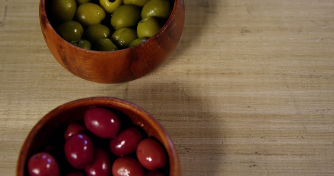 Wooden Bowls with Green and Purple Olives on Wooden Surface - Free Images, Stock Photos and Pictures on Pikwizard.com