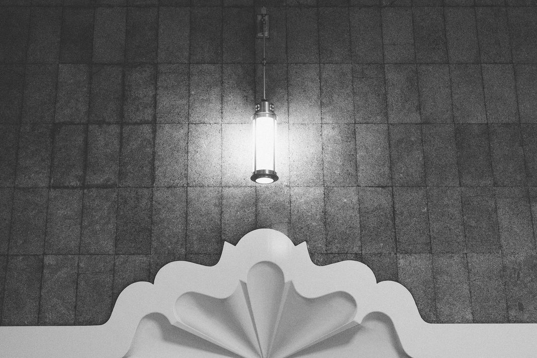 Monochrome Decorative Lighting Fixture Hanging on Tiled Wall