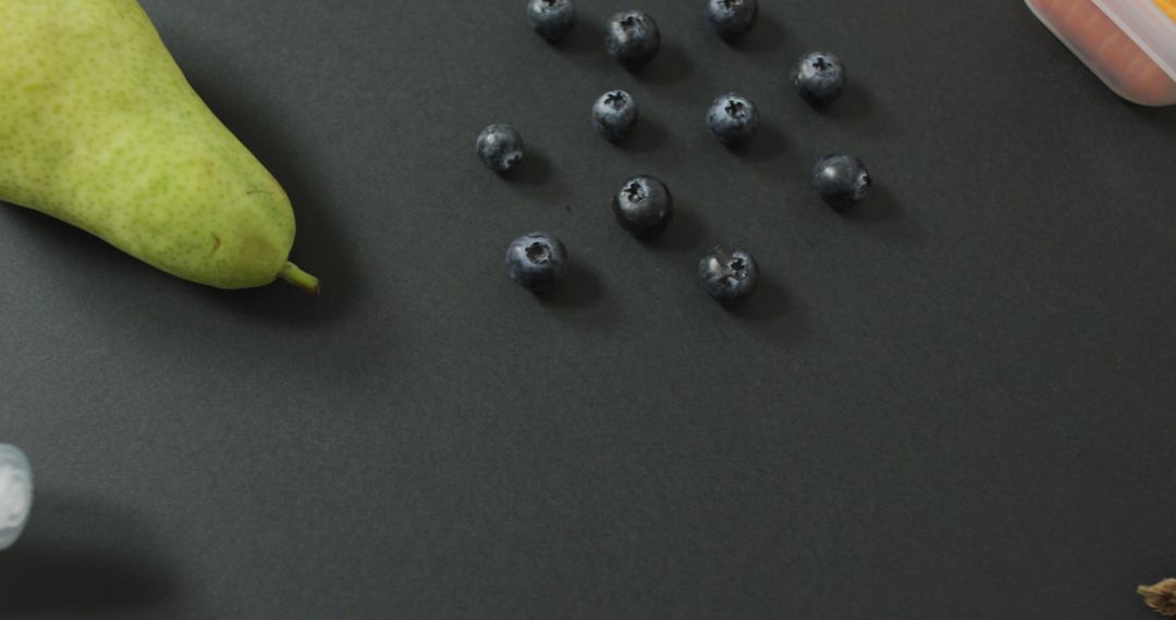 Fresh Pear and Blueberries on Dark Background