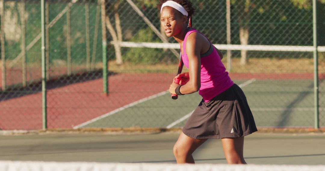 Focused Young Woman Preparing for Tennis Return Serve - Free Images, Stock Photos and Pictures on Pikwizard.com