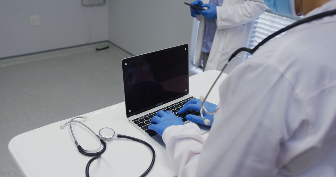 Doctors Studying Medical Records on Laptop in Hospital - Free Images, Stock Photos and Pictures on Pikwizard.com