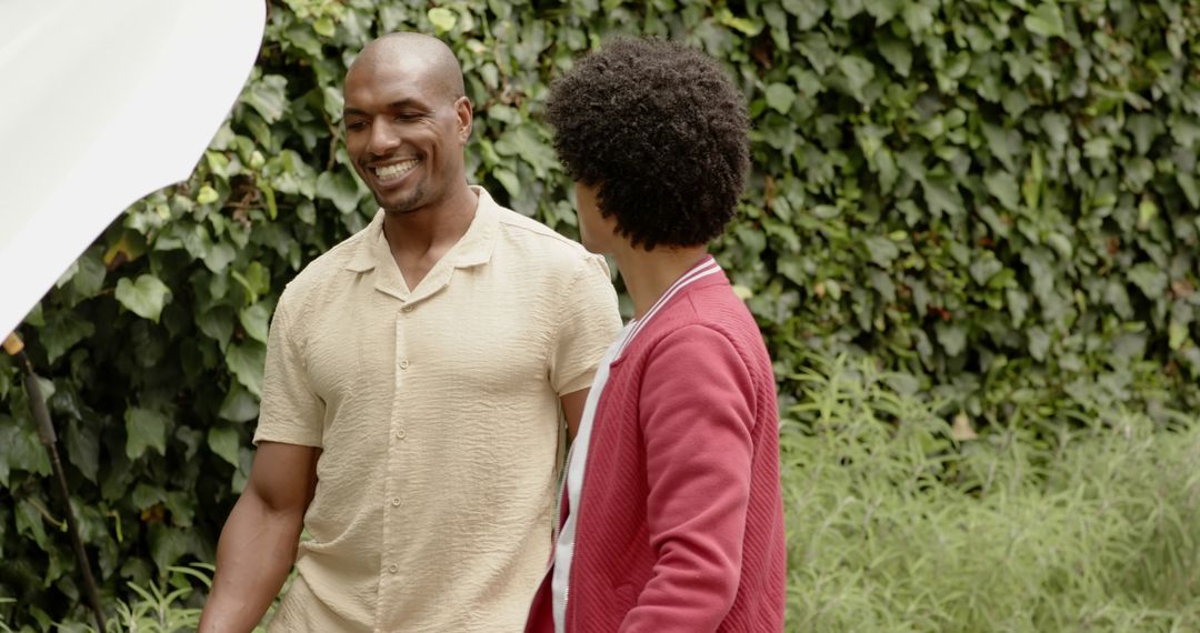 Diverse Father and Son Enjoying Nature Walk Together in Lush Garden