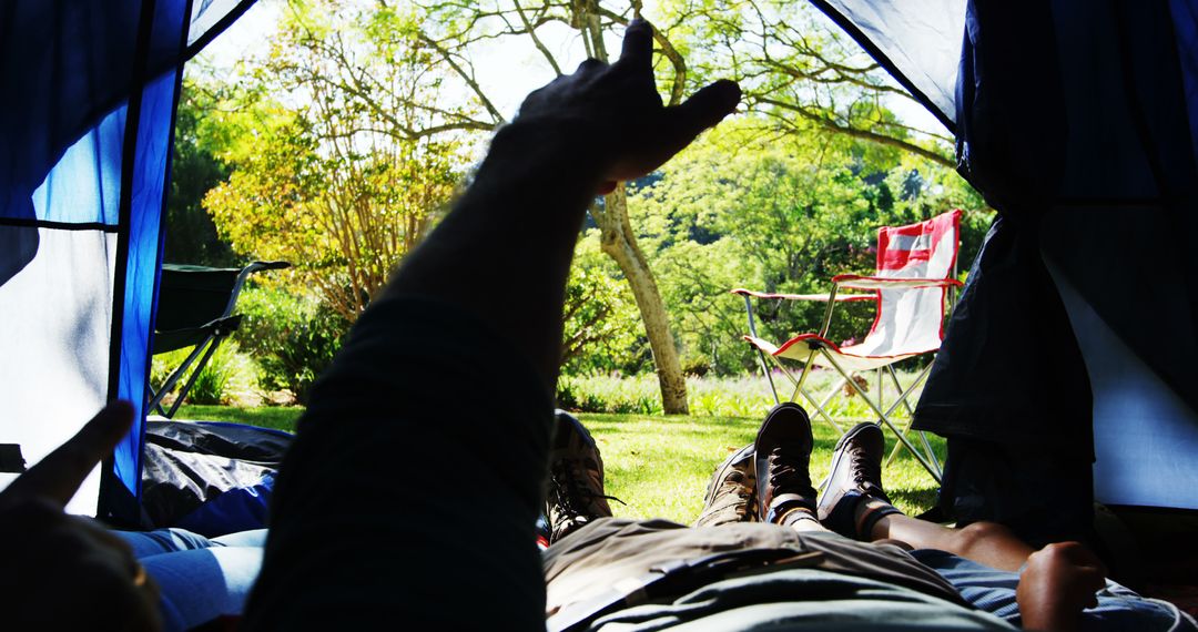Relaxing Inside Tent with Open View to Lush Camping Scene