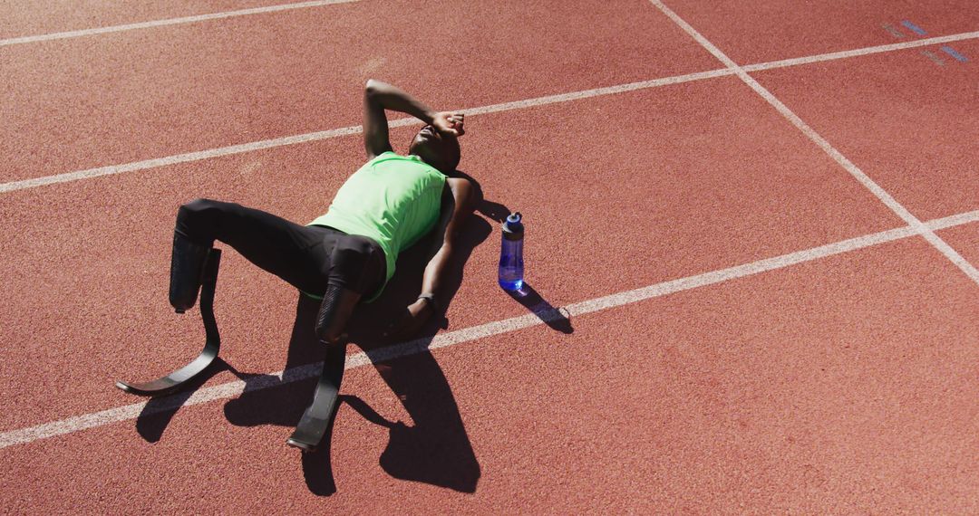 Paralympic Athlete Resting on Track After Intensive Training - Free Images, Stock Photos and Pictures on Pikwizard.com