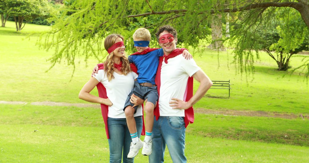 Happy Family Wearing Superhero Costumes in Park - Free Images, Stock Photos and Pictures on Pikwizard.com