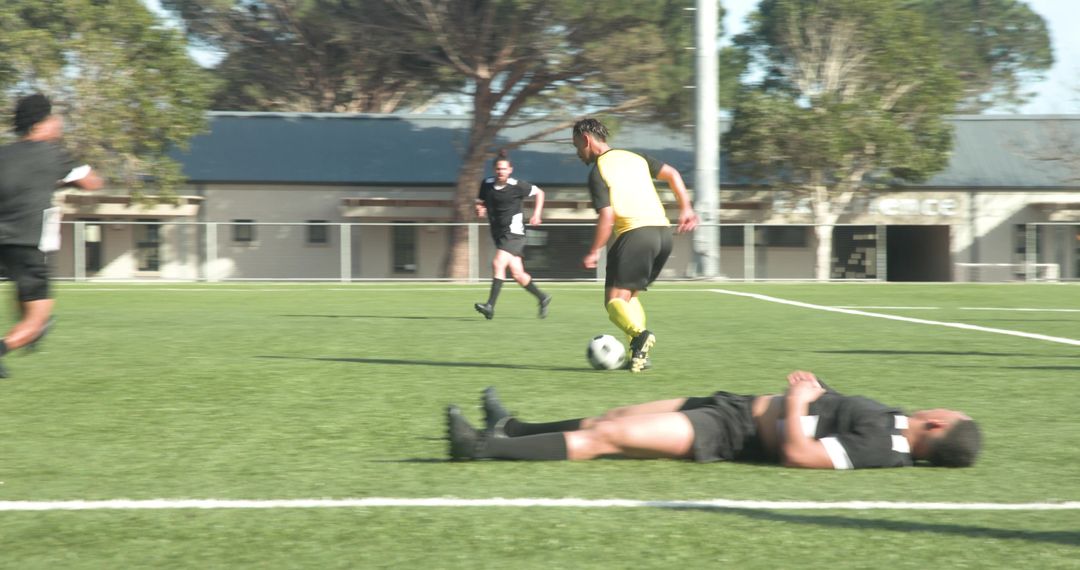 Soccer Player Kicking Ball Towards Goal in Team Competition