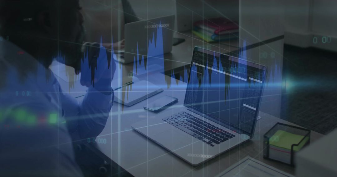 Colleagues analyzing financial charts on laptop with overlaid data visuals for teamwork