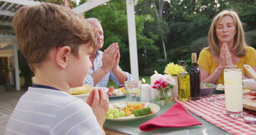 Family Praying Before Meal at Outdoor Dinner Table - Free Images, Stock Photos and Pictures on Pikwizard.com