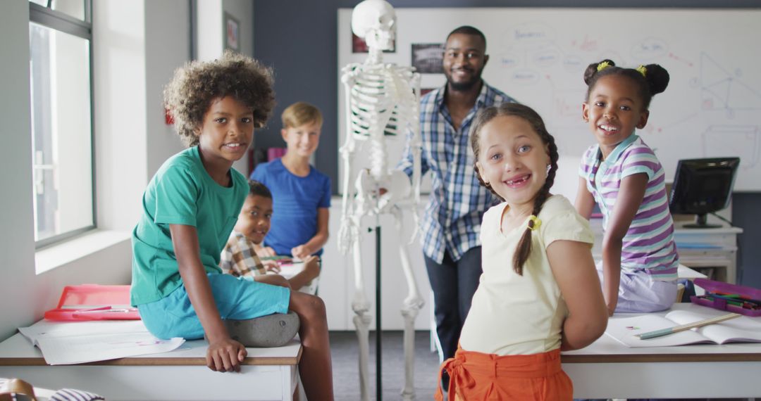 Image of happy african american teacher with class of diverse pupils during anatomy lesson - Free Images, Stock Photos and Pictures on Pikwizard.com