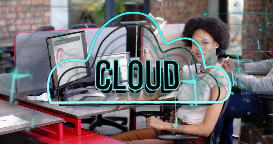 Woman collaborating at dual-monitor workspace with neon CLOUD overlay and network data visualization