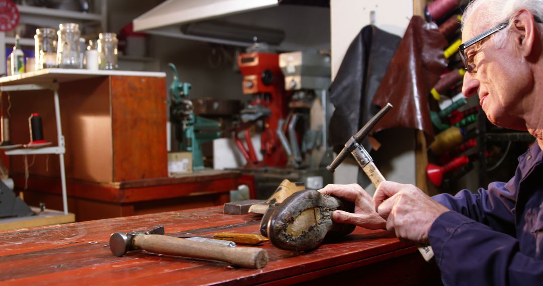 Elderly craftsman working in a rustic workshop - Free Images, Stock Photos and Pictures on Pikwizard.com