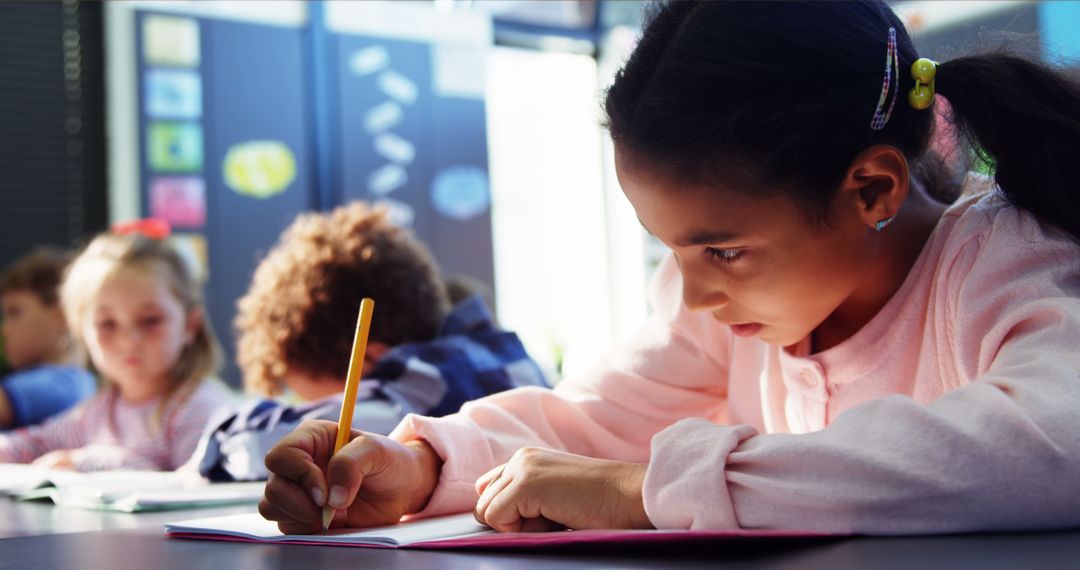 Young Girl Focused on Writing in Classroom - Free Images, Stock Photos and Pictures on Pikwizard.com