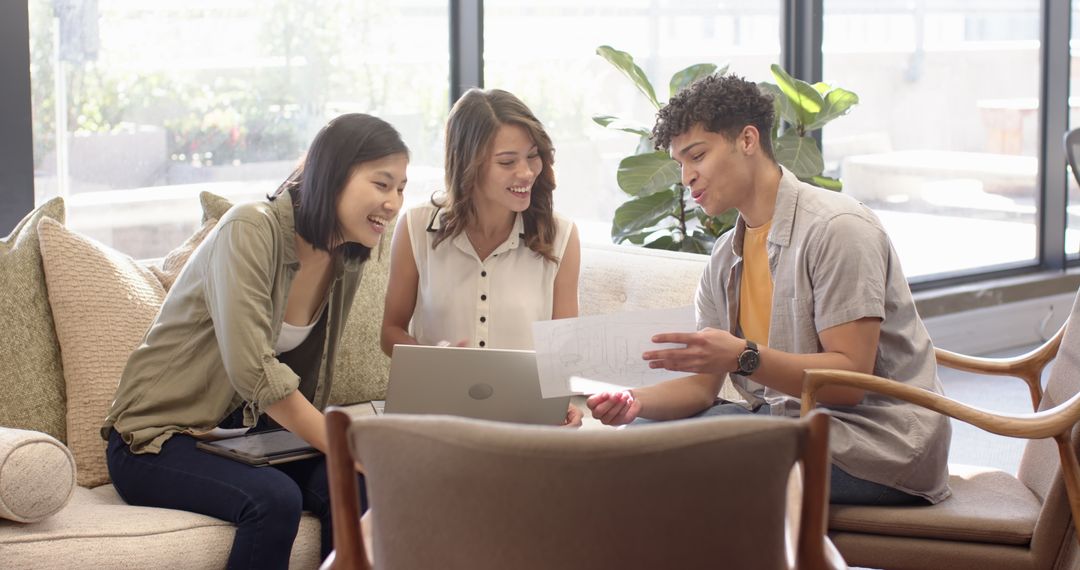 Diverse Team Collaborating on Project in Modern Office Lounge