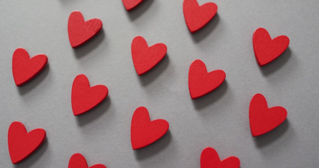 Red Wooden Hearts Pattern on Gray Background Symbolizing Love