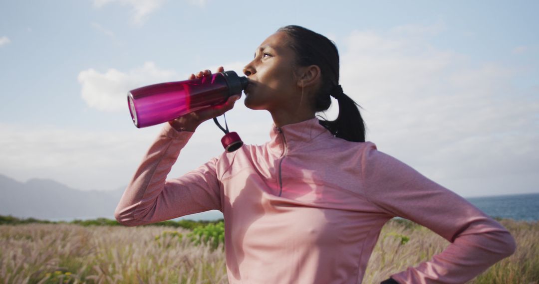 Active Woman Drinking Water from Sports Bottle Outdoors - Free Images, Stock Photos and Pictures on Pikwizard.com