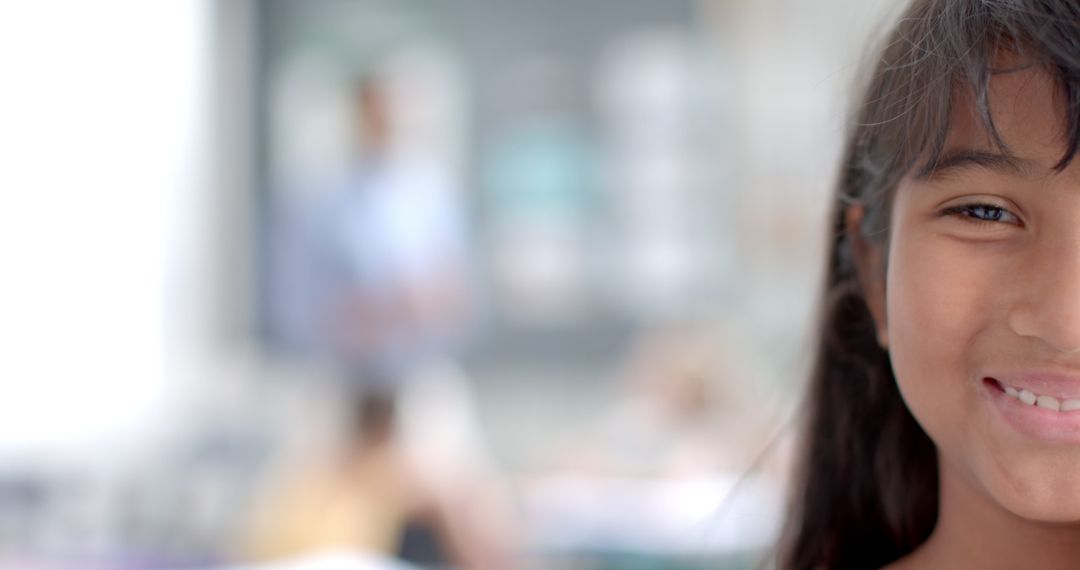 Young Mixed-Race Girl in Focus with Blurred Classroom Background