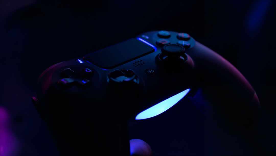 Black Wireless Gamepad Holding with Blue-Purple LED Glow for Moody Neon Gaming Visual