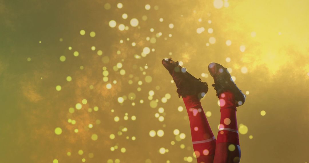 Dynamic Soccer Cleats and Red Socks Against a Sparkling Golden Background