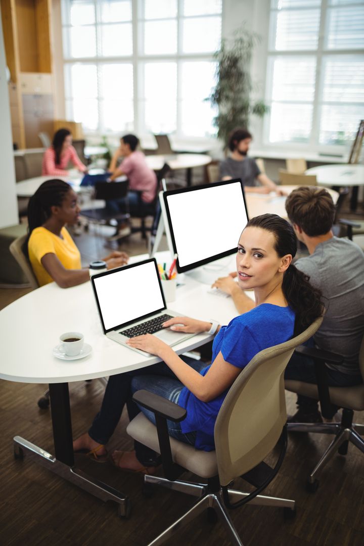 Young Woman Collaborating in Modern Office Workspace