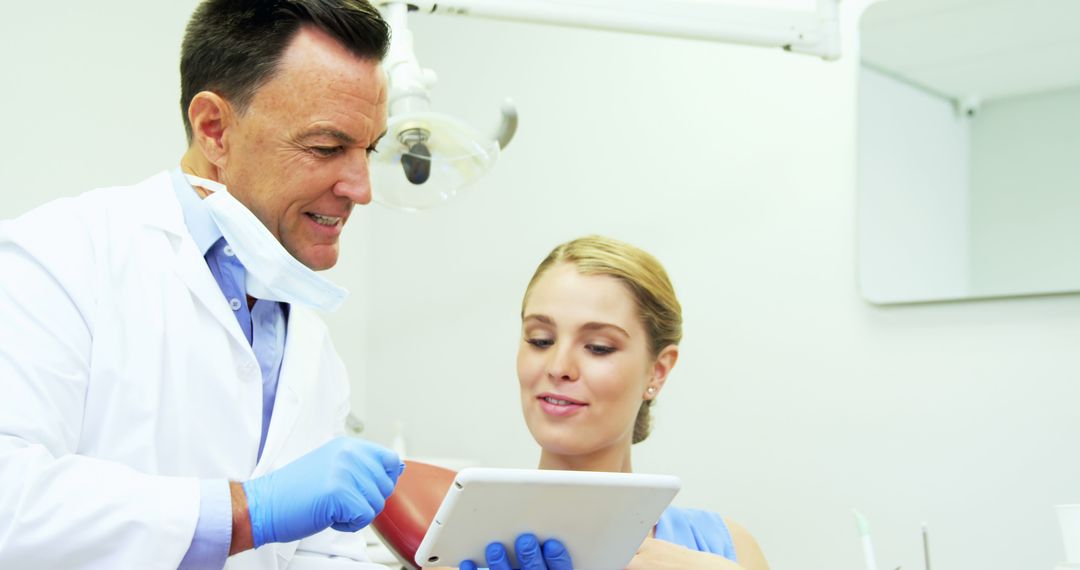 Dentist Showing Patient Dental Procedure on Digital Tablet - Free Images, Stock Photos and Pictures on Pikwizard.com