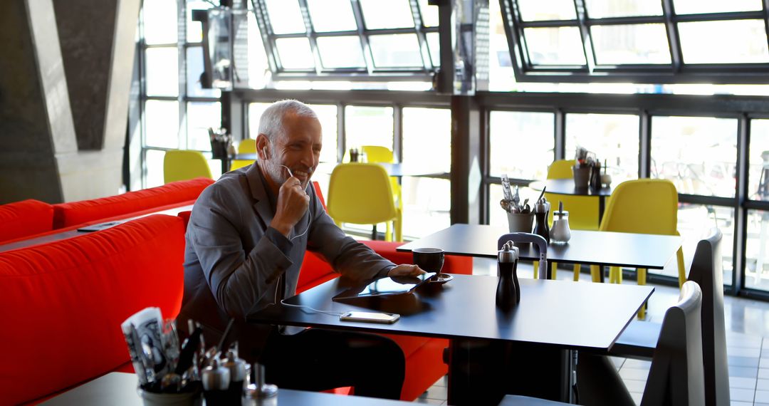 Man Enjoys Leisure Time in Modern Cafe Interior