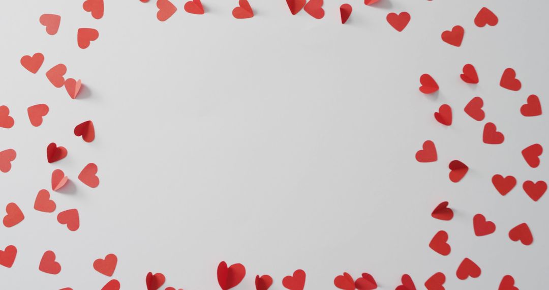 Red Paper Hearts Forming Circular Border on Blank Surface