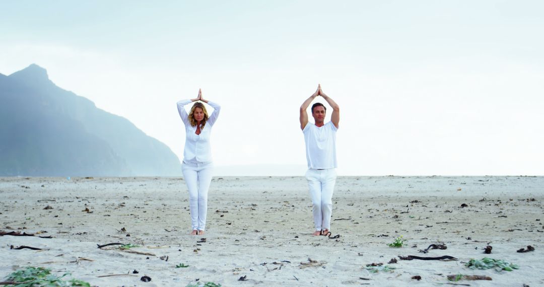 Couple Practicing Yoga on Scenic Beach During Sunrise - Free Images, Stock Photos and Pictures on Pikwizard.com