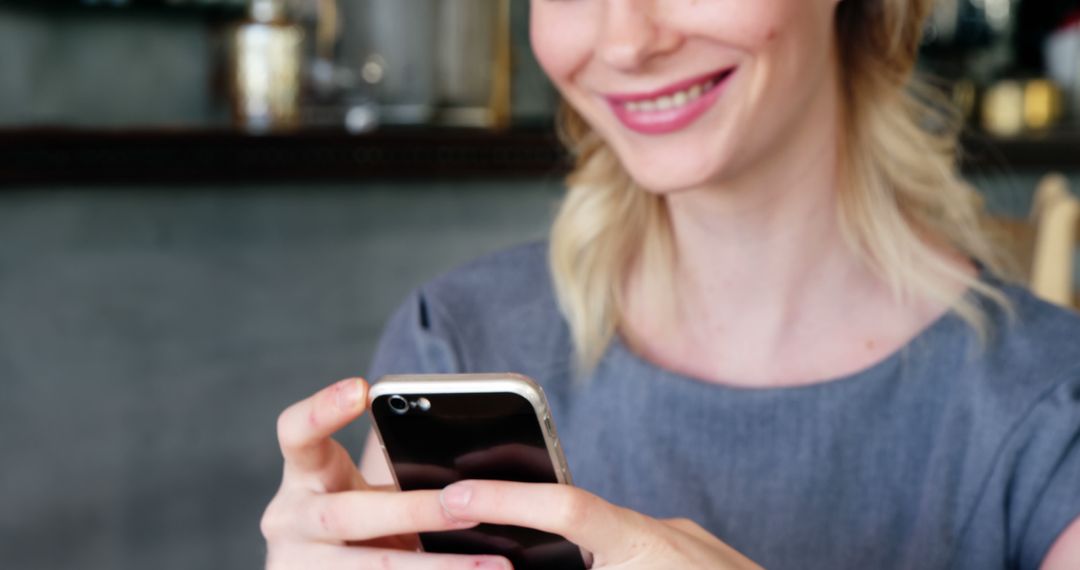 Smiling Woman Texting on Smartphone Indoors - Free Images, Stock Photos and Pictures on Pikwizard.com