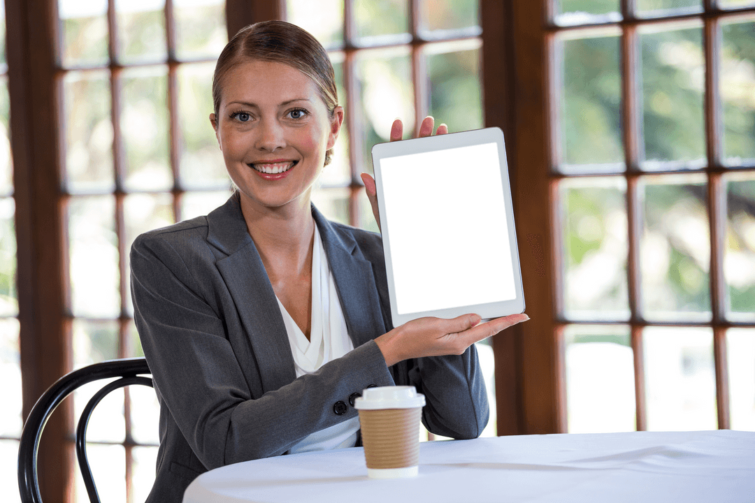 Businesswoman Displaying Transparent Screen Tablet in Cafe