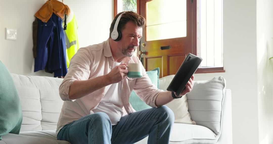 Man Relaxing at Home with Tablet and Headphones