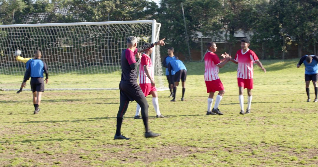 Soccer Referee Directing Players during Intense Match Outdoors