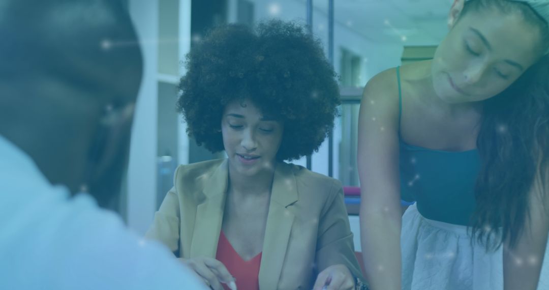 Diverse Team Engaged in Collaborative Discussion with Technology