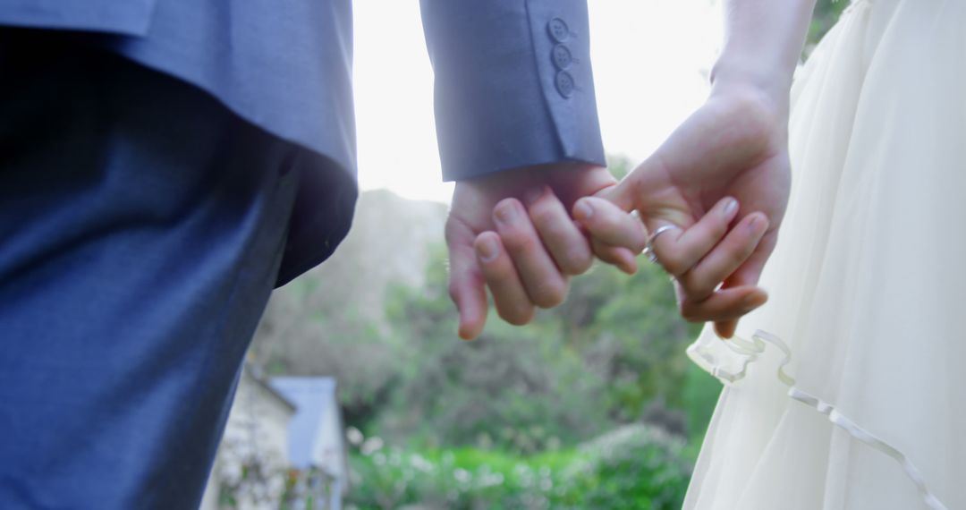 Newlyweds Holding Hands in Garden Sunset - Free Images, Stock Photos and Pictures on Pikwizard.com