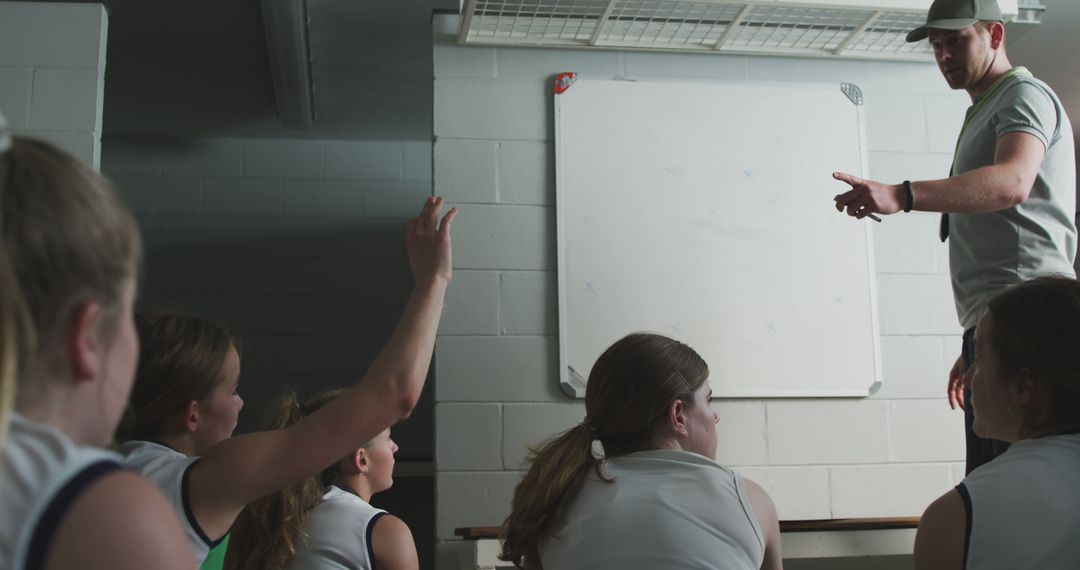 Female students in sportswear listening to coach during review session - Free Images, Stock Photos and Pictures on Pikwizard.com