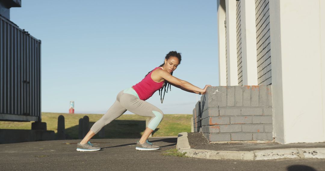 Woman Stretching Before Outdoor Workout Near Brick Wall - Free Images, Stock Photos and Pictures on Pikwizard.com