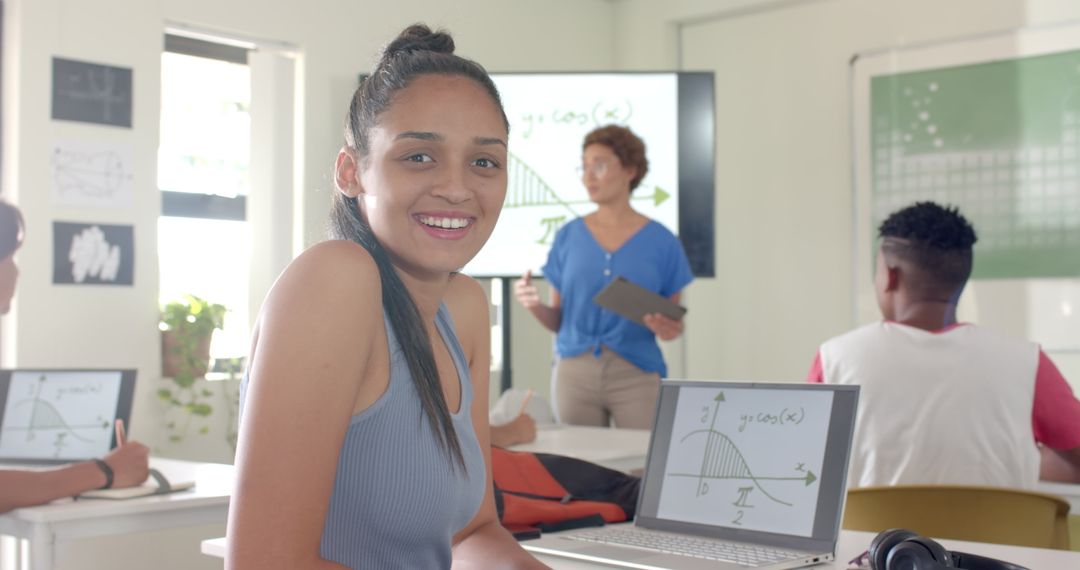 High School Student Smiling in Math Class with Laptop