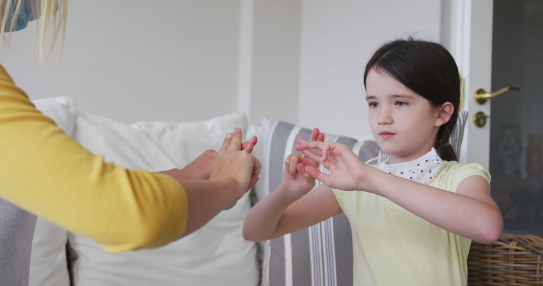 Mother and Daughter Playing Finger Game at Home