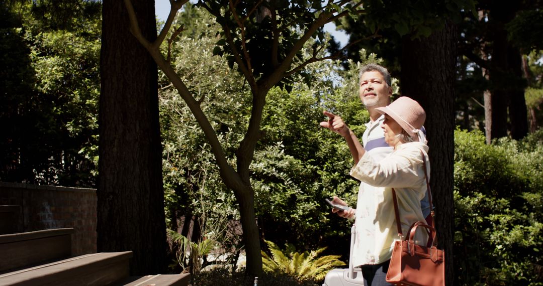 Senior Couple Enjoying Nature in Sunny Forest - Free Images, Stock Photos and Pictures on Pikwizard.com