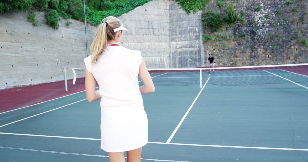 Young Woman Playing Tennis with Partner on Outdoor Court - Free Images, Stock Photos and Pictures on Pikwizard.com