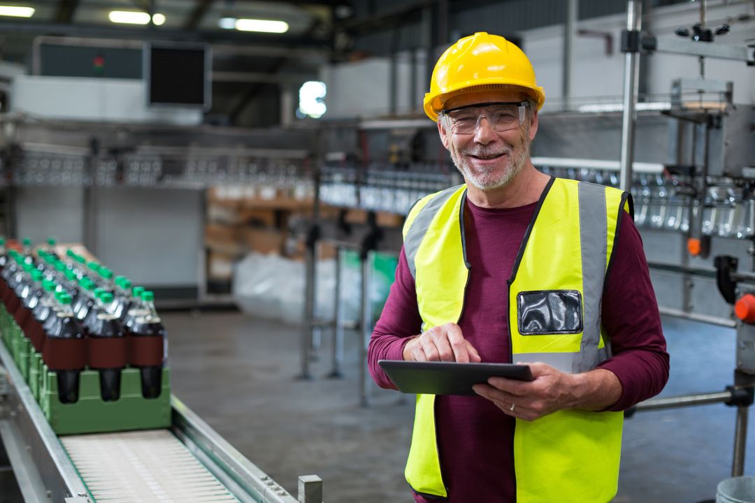 Senior Industrial Worker Using Tablet in Beverage Plant