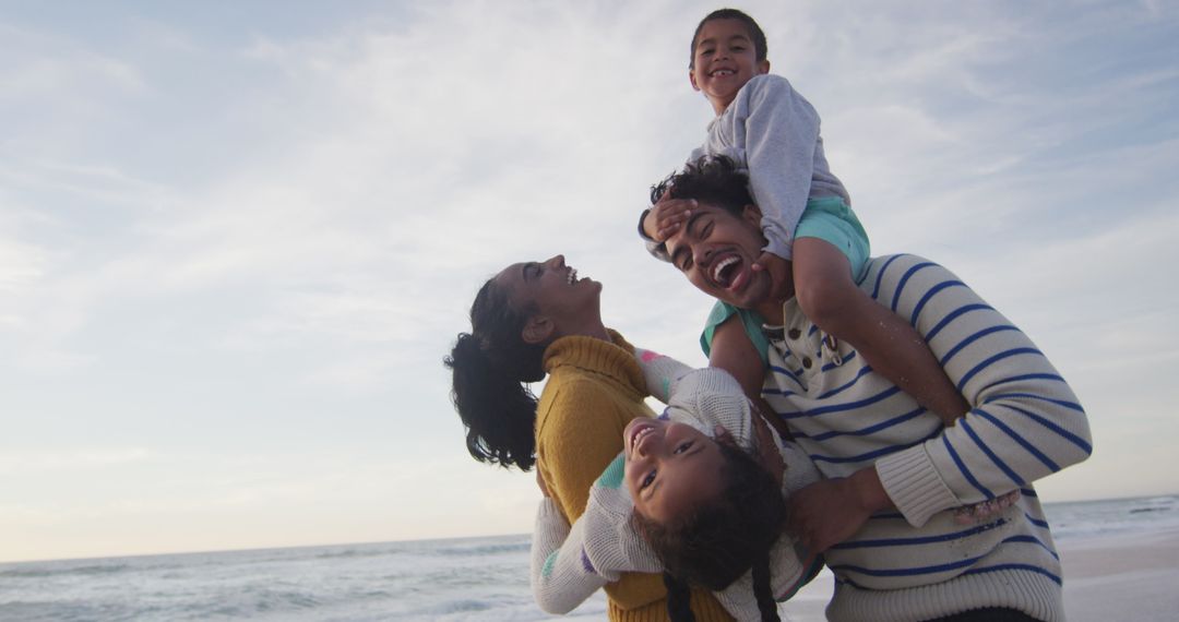 Joyous Family Bonding at Beach during Sunset