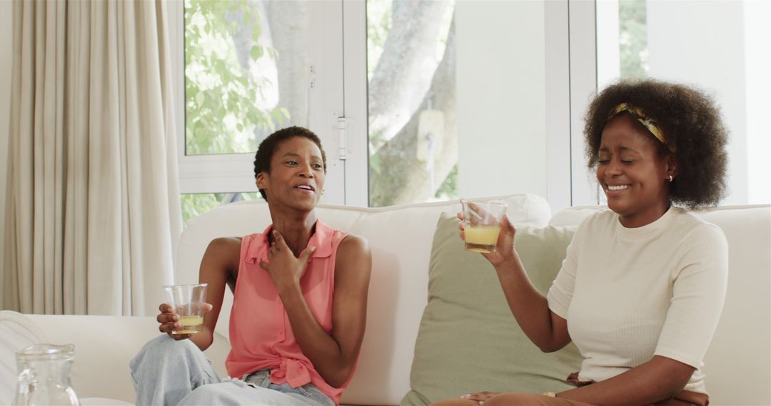 Two Women Relaxing at Home Enjoying Refreshing Drinks
