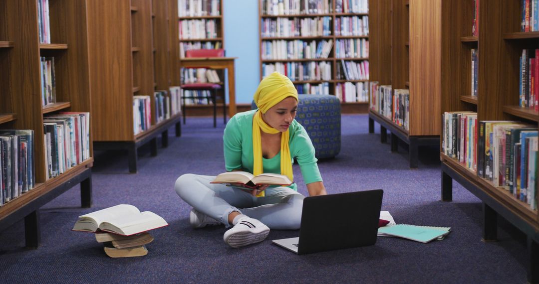 Young Woman Studying on Floor in Library - Free Images, Stock Photos and Pictures on Pikwizard.com