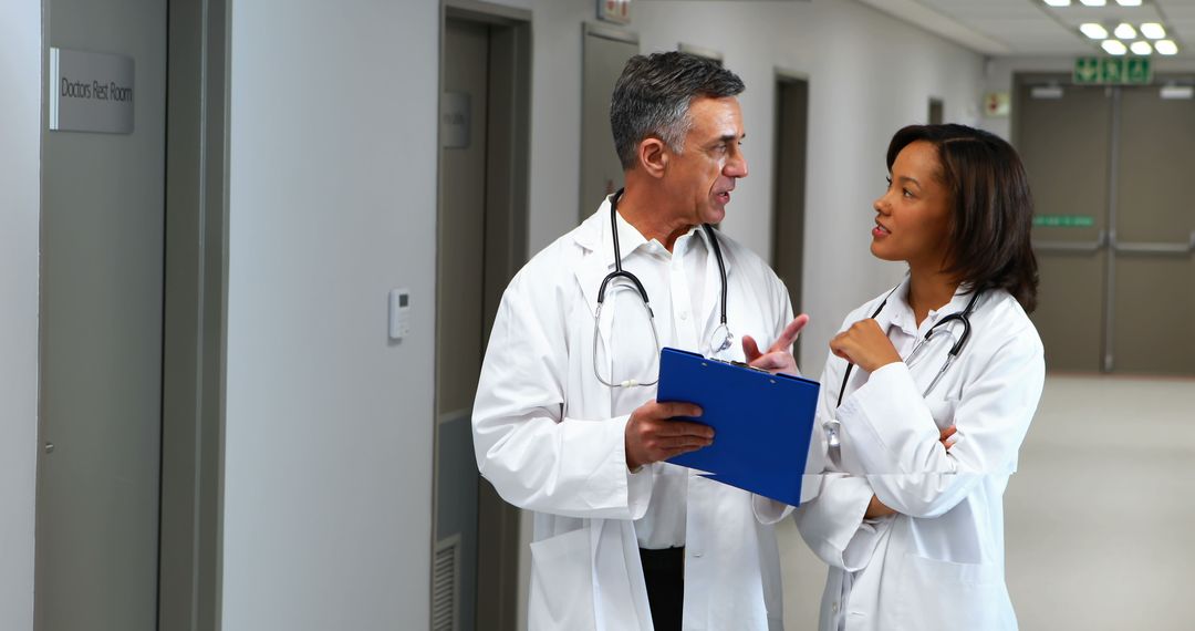 Doctors Collaborating in Hospital Corridor with Copy Space