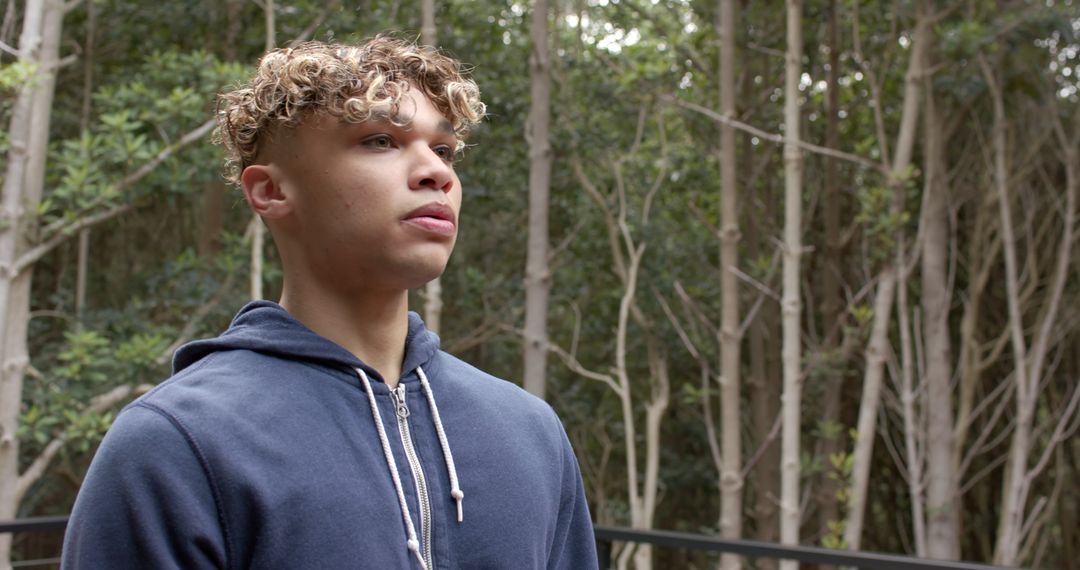 Young Man Embracing Tranquility in Forest Balcony Setting