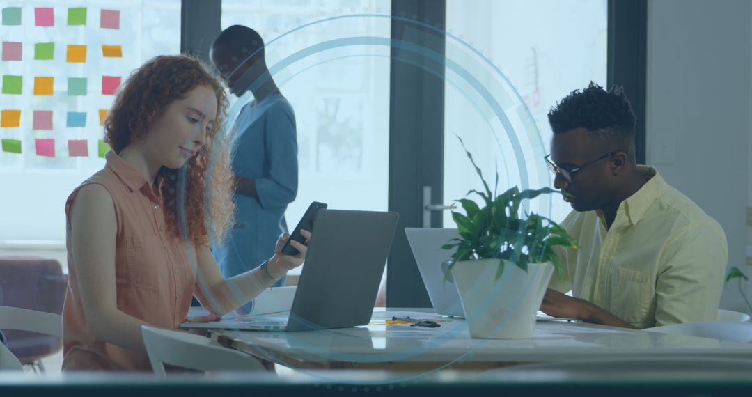 Diverse Professionals Collaborating with Digital Interface in Modern Office