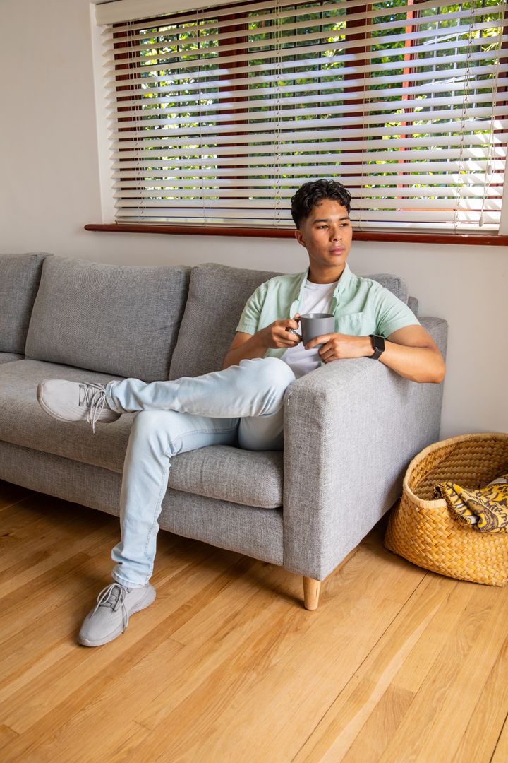 Relaxed Man with Mug Reflecting by Window Light